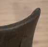 A close-up view of the top edge of a dark gray leather chair. Produktbild-Vorschau
