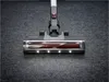Close-up of a cordless vacuum cleaner head with LED lights on a carpeted floor. Produktbild-Vorschau