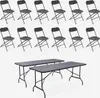 A set of dark gray folding tables and chairs arranged on a white background. Anteprima dell’immagine prodotto