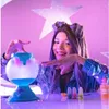 A young person is shown interacting with a slime potion maker kit, with colorful bottles and mist visible. Náhled obrázku produktu