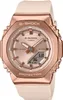 A close-up studio shot of a rose gold Casio G-Shock watch with a pink band against a white background. Voir les images du produit