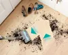 A vacuum cleaner is shown cleaning up dirt and debris on a wooden floor, with gardening tools and shoes nearby. Anteprima dell’immagine prodotto