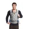 A man is wearing a baby carrier with a baby inside. Náhled obrázku produktu