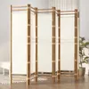 A four-panel folding screen made of bamboo and canvas, set up in a room with a plant in the background. Produktbild-Vorschau