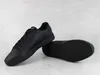 A pair of black Puma sneakers are shown on a light gray background. Produktbild-Vorschau