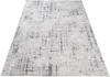 A light gray rug with a distressed geometric pattern is shown from a diagonal angle on a white background. Anteprima dell’immagine prodotto