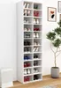 A tall, white shoe rack filled with various shoes, standing against a white wall next to a potted plant. Produktbild-Vorschau