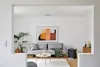 A living room scene with a couch, coffee table, and an air purifier. Anteprima dell’immagine prodotto