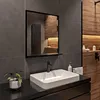 A modern bathroom with a sink, mirror, and wooden accents. Produktbild-Vorschau