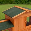 Close-up view of a wooden animal house with a green roof. Produktbild-Vorschau