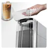 A close-up of an ice maker with a hand pouring ice into it, and a glass of iced coffee in the background. Anteprima dell’immagine prodotto