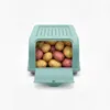 A teal storage box filled with potatoes, with its front flap open. Produktbild-Vorschau