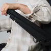A person's arm rests on the armrest of a chair. Produktbild-Vorschau