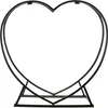 A black metal heart-shaped firewood rack on a white background. Produktbild-Vorschau
