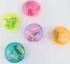 Five small, round containers of earplugs in different colors, arranged on a white background. Produktbild-Vorschau