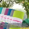 Multiple colorful blankets are displayed in a natural outdoor setting with trees and a tent. Produktbild-Vorschau