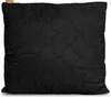 A black quilted pillow with a scalloped pattern is shown flat against a white background. A small tan tag with text is visible in the top left corner. Podgląd zdjęcia produktu