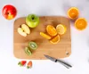 A collection of fruits and a cutting board with a knife. Produktbild-Vorschau