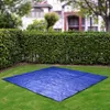 A blue tarp is laid out on a green lawn in front of a manicured hedge and a blurred house. Produktbild-Vorschau