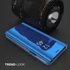 A blue flip phone case is displayed in front of a camera lens. Produktbild-Vorschau