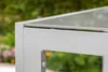 A close-up view of the corner of a silver aluminum garden table with a glass top. Produktbild-Vorschau
