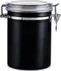 A black metal coffee canister with a clear lid and silver clasps. Podgląd zdjęcia produktu