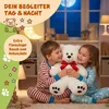 Two children are hugging a large white teddy bear in a bedroom at night. Anteprima dell’immagine prodotto
