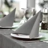 A table setting with folded gray napkins on white plates, set for a meal. Produktbild-Vorschau