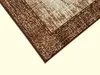 A close-up view of a corner of a rug with a textured pattern. Náhled obrázku produktu