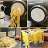 A collage of images showing homemade pasta being made and dried. Voir les images du produit
