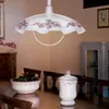 A dining room with a chandelier, table, chairs, and decorative items. Náhled obrázku produktu