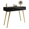 A black console table with gold legs and drawers, decorated with a mirror and cosmetic bottles. Náhled obrázku produktu