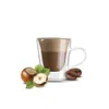 A cup of coffee with hazelnuts and coffee beans. Voir les images du produit
