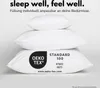 A stack of three white pillows against a light gray and white background. The bottom pillow has a black and white OEKO-TEX certification label. Produktbild-Vorschau