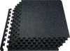 A stack of interlocking black foam floor mats with white speckles, viewed from a slightly elevated angle. Voir les images du produit