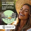 A woman wearing a straw hat is smiling broadly, with a set of outdoor furniture (two chairs and a table) displayed in a green circular overlay in the foreground. Produktbild-Vorschau