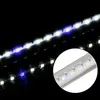 A close-up view of an LED light strip with alternating white and blue lights, reflecting on a dark surface. Podgląd zdjęcia produktu
