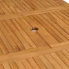A close-up view of a wooden table surface with a hole in the center, likely for an umbrella. Produktbild-Vorschau