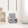 A baby swing is hanging in a room with a shelf and some decorative hearts on the wall. Produktbild-Vorschau