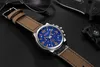 A watch is placed on a black surface with other items like sunglasses and a knife. Produktbild-Vorschau