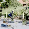 A table set for an outdoor event with LED candles and floral arrangements. Náhled obrázku produktu