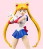 A studio shot of a Sailor Moon action figure against a plain pink background. Produktbild-Vorschau
