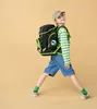 A young boy wearing a backpack and standing with his legs spread. Produktbild-Vorschau
