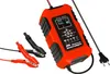 An orange and black battery charger with alligator clips and a power cord, shown against a white background. Voir les images du produit