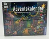 The image shows the front of a board game box for an advent calendar. The box features a colorful illustration of a toy store at night with various toys, including a dinosaur, a teddy bear, and cars, along with Christmas decorations. Produktbild-Vorschau