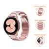 A smartwatch with a rose gold metal band is shown, with close-up insets highlighting features like the clasp and material. Produktbild-Vorschau