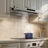 A kitchen scene with a range hood over a stovetop with a pot on it. Náhľad obrázku produktu