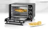 A black and silver mini oven with its door open, showing food inside, and a plate of mini pizzas in front. Náhled obrázku produktu