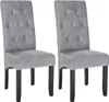Two gray upholstered dining chairs with tufted backs and black wooden legs are shown against a white background. Produktbild-Vorschau