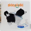 A plush toy dog with a leash and remote control, set against a light background with some shelving and a teddy bear in the background. Anteprima dell’immagine prodotto